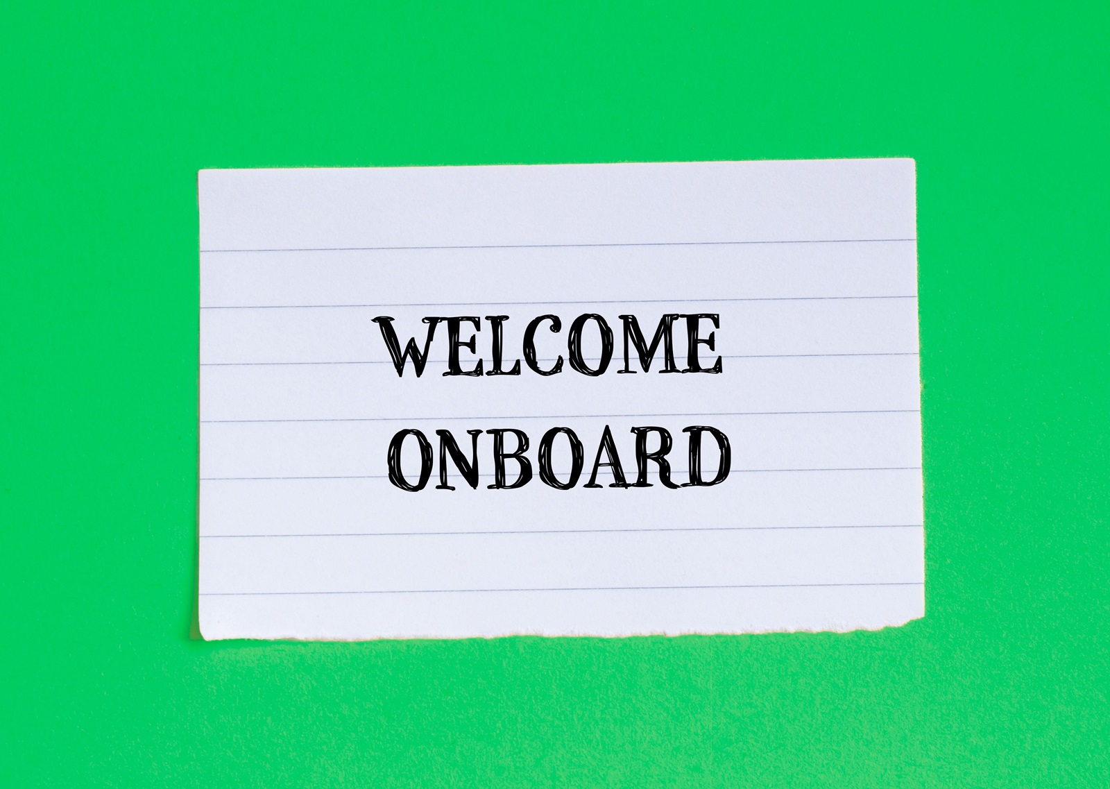 Welcome,onboard,lettering,on,ripped,paper,piece,with,green,background.